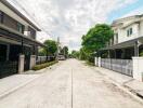 Street view of residential buildings with trees