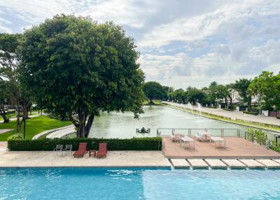 Pool and lake view with surrounding seating area