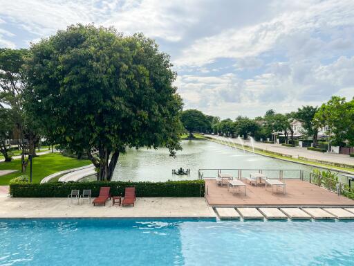 Pool and lake view with surrounding seating area