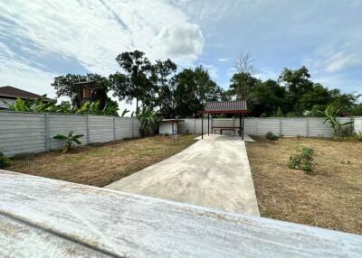Backyard with covered patio and concrete path