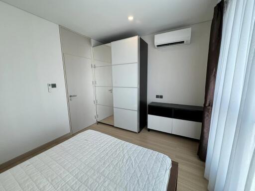 Modern bedroom with white minimalistic furniture and air conditioning