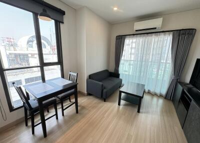 Modern living room with dining area and large windows