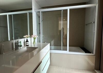 Modern bathroom with dual sinks and a walk-in shower