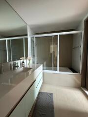 Modern bathroom with dual sinks and a walk-in shower