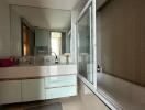 Modern bathroom with large mirror and bathtub