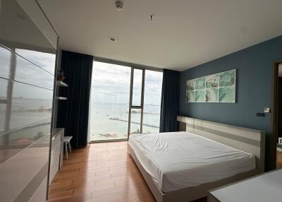 Modern bedroom with large window, sea view, and contemporary decor