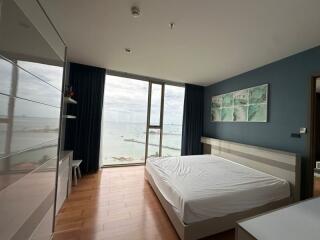 Modern bedroom with large window, sea view, and contemporary decor