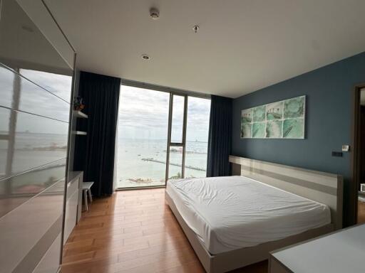 Modern bedroom with large window, sea view, and contemporary decor