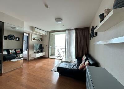 Modern living room with wooden flooring and balcony view