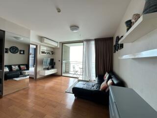 Modern living room with wooden flooring and balcony view