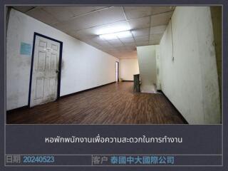 Long hallway with wooden floor and white walls