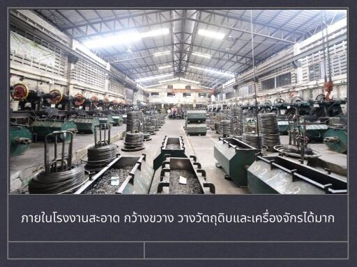 Interior view of a clean and spacious factory with equipment and materials
