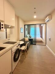 Small modern studio apartment with kitchen and bedroom
