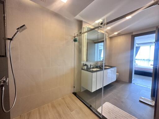 Modern bathroom with a view of a bedroom