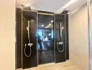 Modern bathroom with dual rain showers and black tile wall