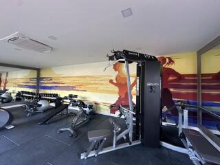 Well-equipped gym with vibrant wall art