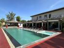 Outdoor pool area with lounge chairs and building in the background