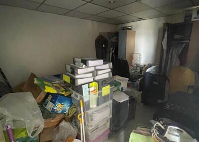 Cluttered storage room with various items and boxes