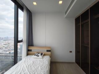 Modern bedroom with large window and city view