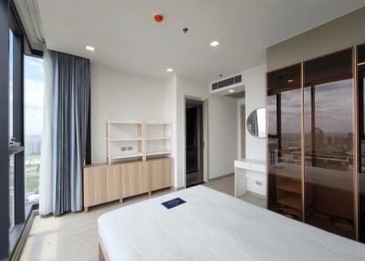 Modern bedroom with large windows and wooden furniture