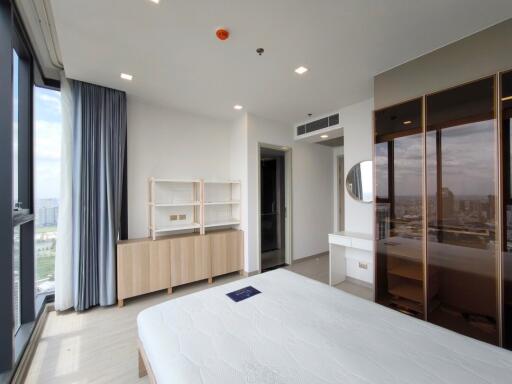 Modern bedroom with large windows and wooden furniture