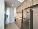 Modern kitchen with sleek cabinetry and stainless steel refrigerator