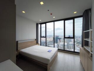 Bedroom with a large window and city view