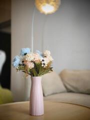 Vase with flowers on a coffee table in a living room