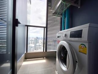 Utility room with washing machine and city view