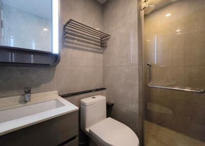 Modern bathroom with shower, vanity, and toilet