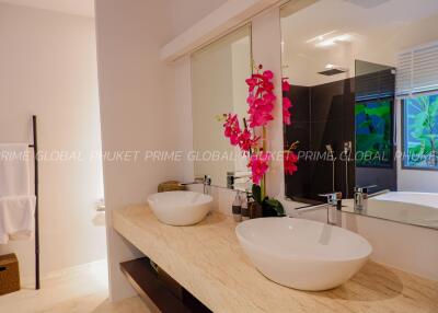 Modern bathroom with double sinks and decorative orchid