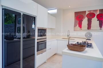 Modern kitchen with white cabinetry and stainless steel appliances