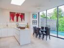 Modern kitchen area with dining table and pool view