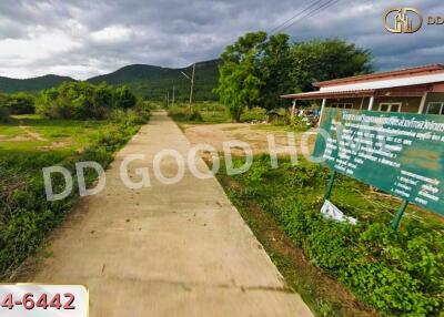 Pathway leading to a building with greenery around