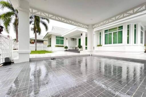 Spacious covered driveway of a modern white house