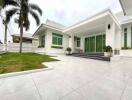 Modern white house with large windows and spacious outdoor area