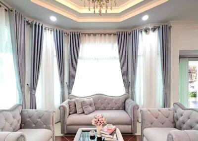 Elegant living room with luxurious grey furniture and chandelier