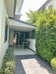 Covered outdoor entrance with greenery