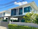 Modern two-story house with a well-maintained exterior and front yard