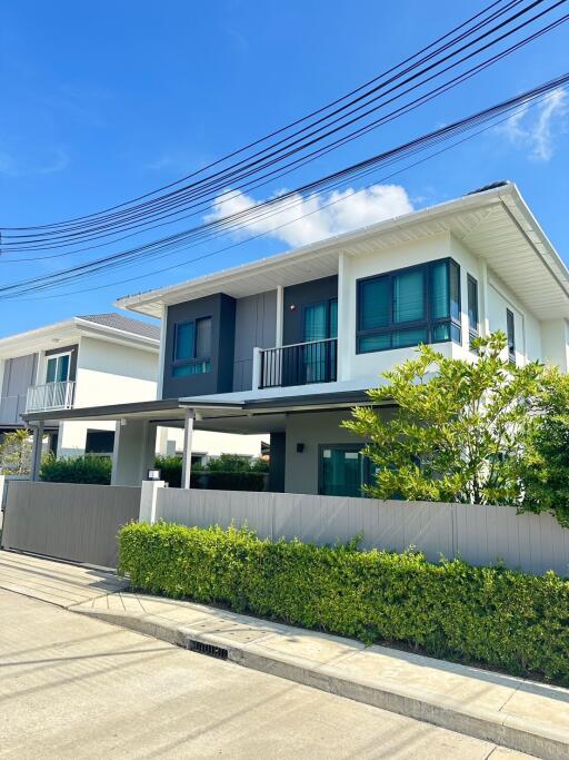 Modern two-story house with a well-maintained exterior and front yard