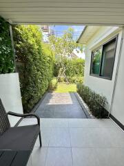 Outdoor patio with greenery and seating