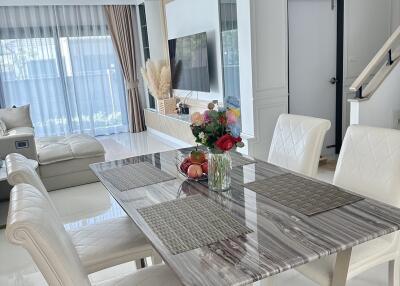 Modern dining room with marble table and upholstered chairs