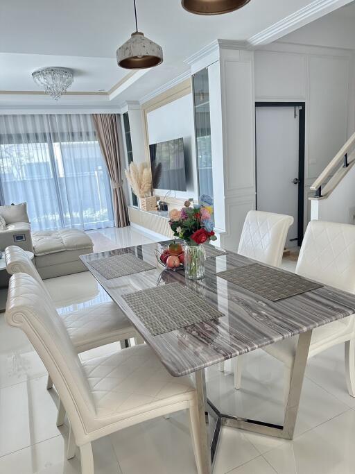 Modern dining room with marble table and upholstered chairs