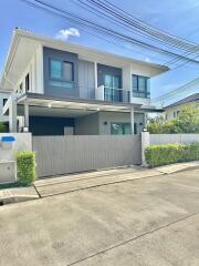 Two-story modern house with balcony and garage