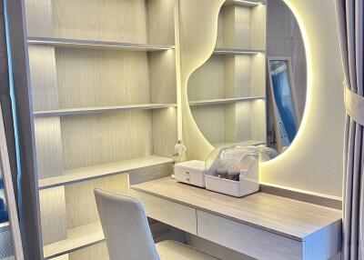 Bedroom with built-in shelves and vanity area