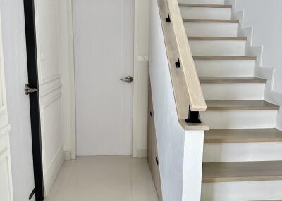 Modern staircase with wooden handrail and steps