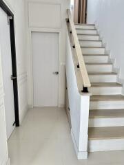 Modern staircase with wooden handrail and steps