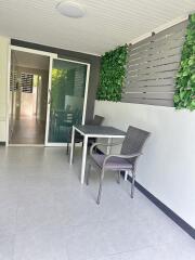 Enclosed patio with dining table and chairs