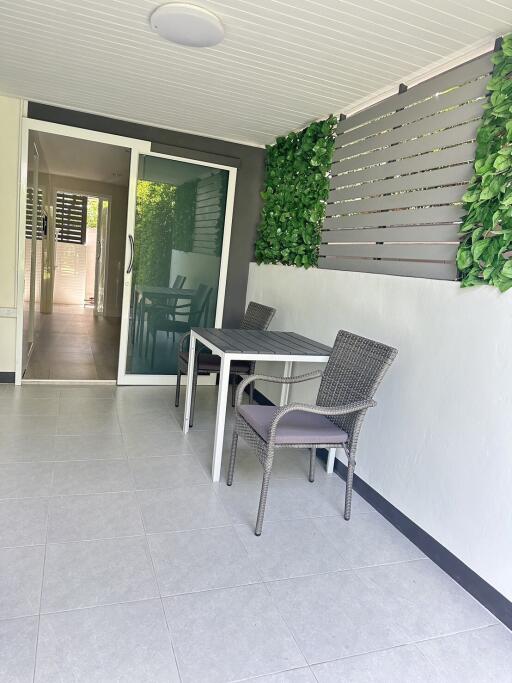 Enclosed patio with dining table and chairs