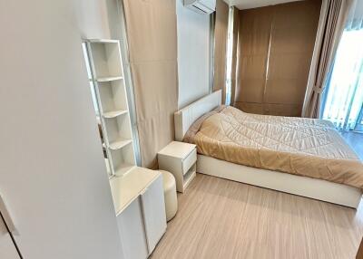 Modern bedroom with wooden flooring and beige design elements